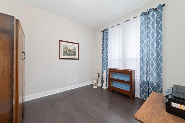 office space with dark wood-type flooring and baseboards