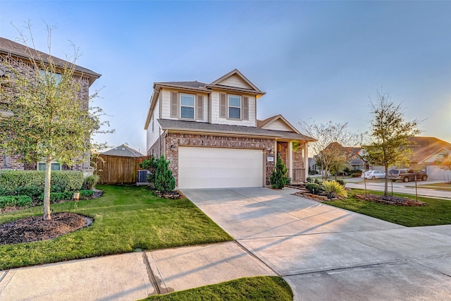 view of front of property with a front yard, fence, an attached garage, concrete driveway, and brick siding