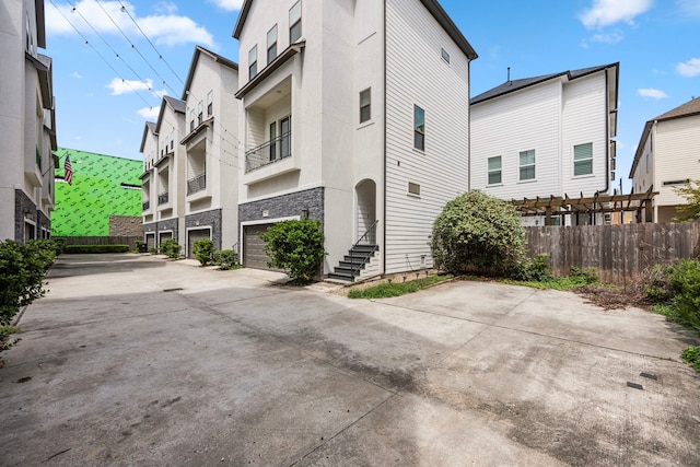 exterior space featuring driveway and fence