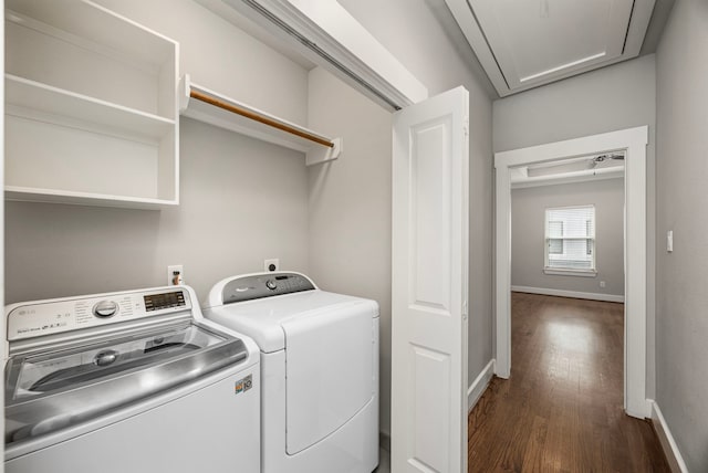 washroom featuring dark wood-style flooring, attic access, separate washer and dryer, laundry area, and baseboards