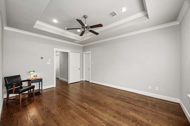 living area with dark wood-type flooring, a raised ceiling, visible vents, and ornamental molding