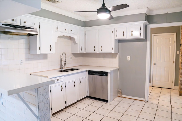 kitchen with light countertops, stainless steel dishwasher, white cabinets, a sink, and under cabinet range hood