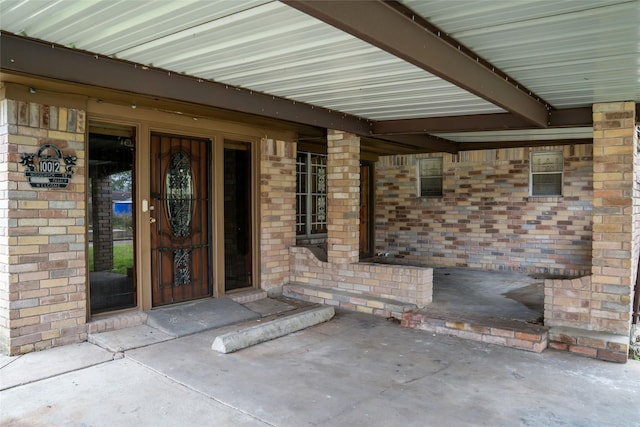 doorway to property with brick siding