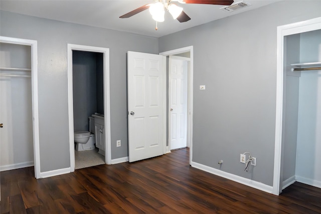 unfurnished bedroom featuring visible vents, dark wood-type flooring, connected bathroom, ceiling fan, and baseboards