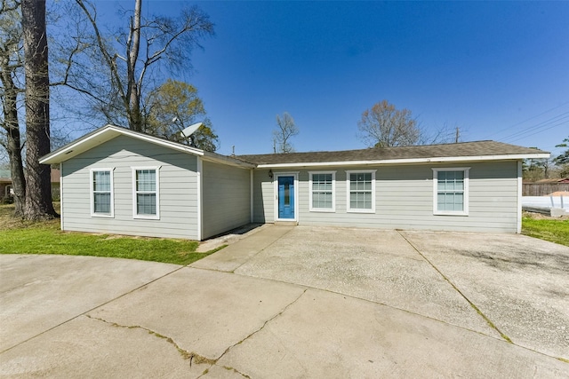 ranch-style home with concrete driveway