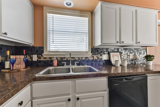 kitchen featuring a sink, decorative backsplash, black dishwasher, and white cabinets