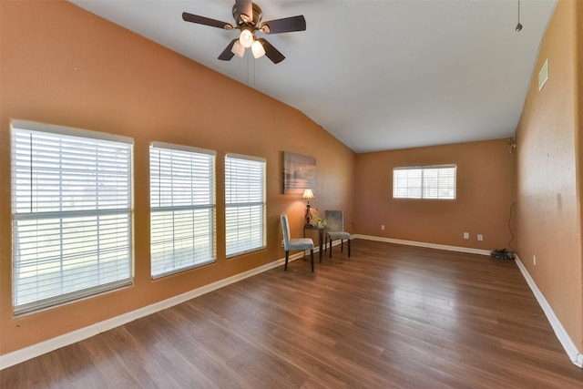 unfurnished room featuring visible vents, wood finished floors, baseboards, ceiling fan, and vaulted ceiling