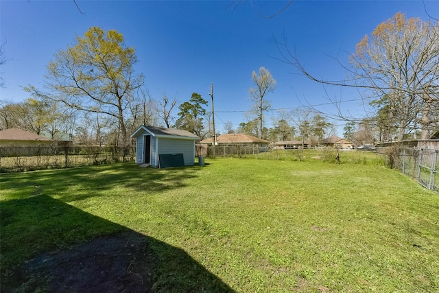 view of yard featuring a fenced backyard, an outdoor structure, and a shed