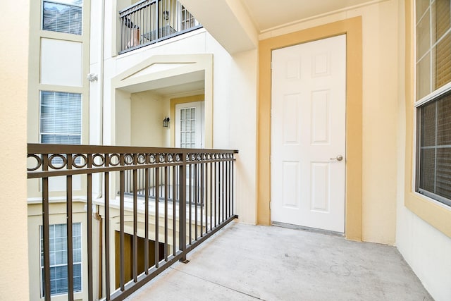 doorway to property with a balcony and stucco siding