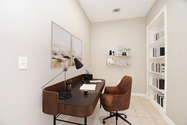 office space with baseboards, visible vents, and tile patterned floors