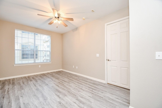 unfurnished room with ceiling fan, baseboards, and wood finished floors