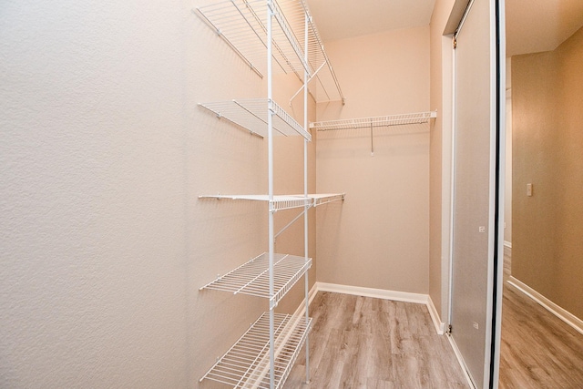 spacious closet with wood finished floors