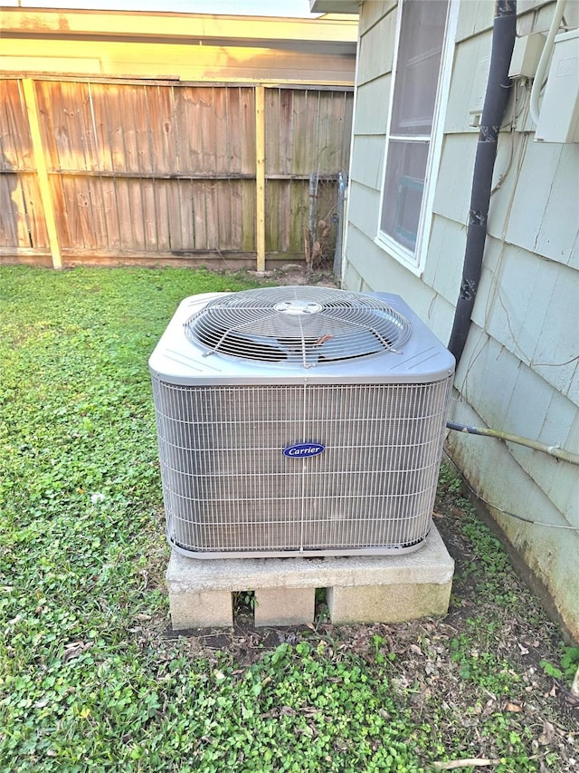 exterior details featuring central AC unit and fence