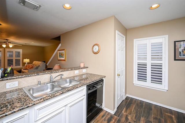 kitchen featuring black dishwasher, visible vents, dark wood-type flooring, a sink, and recessed lighting