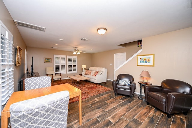 living area with ceiling fan, baseboards, visible vents, and wood tiled floor