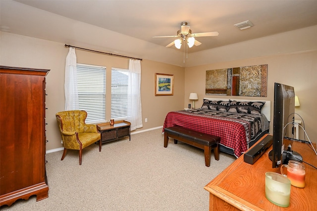 carpeted bedroom with a ceiling fan, visible vents, and baseboards