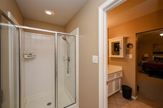 full bathroom featuring a stall shower, tile patterned flooring, vanity, and ensuite bathroom