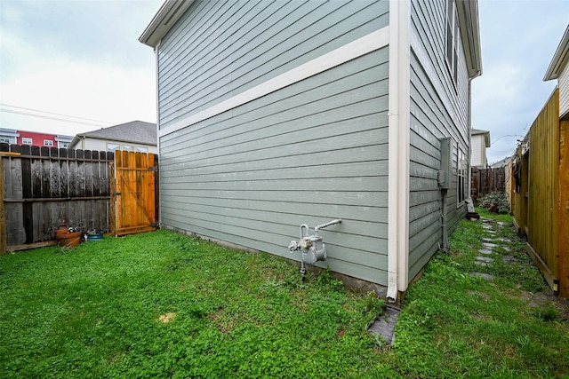 view of property exterior featuring a yard and a fenced backyard