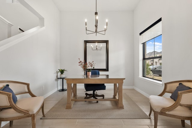 home office featuring light wood-type flooring, a notable chandelier, and baseboards