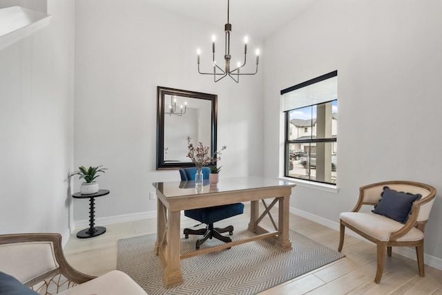 office with baseboards, an inviting chandelier, and light wood-style floors