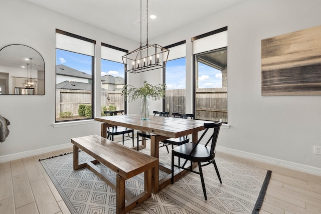 dining room with light wood finished floors, plenty of natural light, baseboards, and recessed lighting