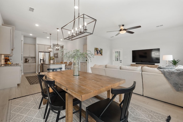 dining area with visible vents, light wood-type flooring, a ceiling fan, and recessed lighting