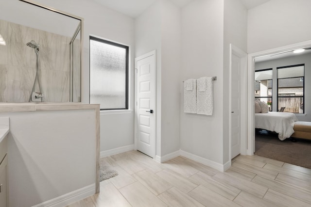 full bath featuring a walk in shower, ensuite bath, and baseboards