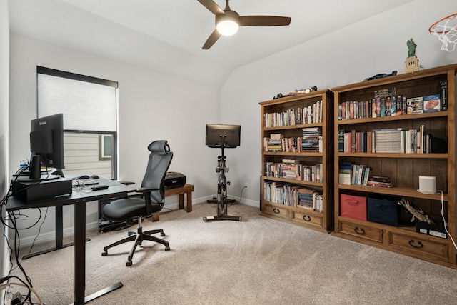 office area with ceiling fan, carpet, baseboards, and vaulted ceiling