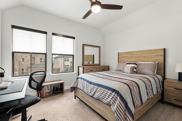 carpeted bedroom with vaulted ceiling, baseboards, and ceiling fan