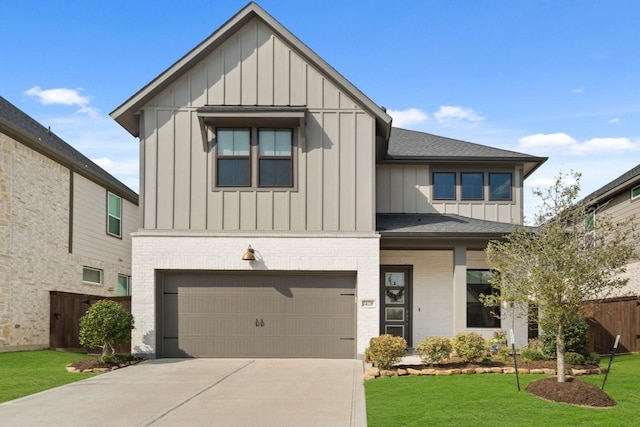 modern farmhouse with a garage, a shingled roof, a front lawn, board and batten siding, and brick siding