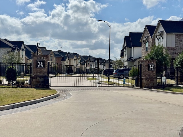 view of gate featuring fence and a residential view