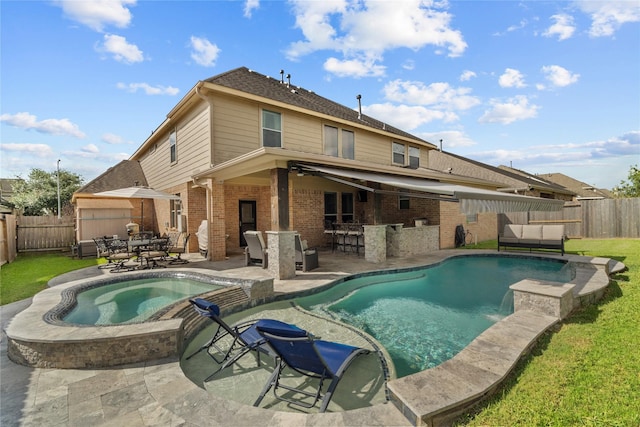 view of swimming pool with outdoor dry bar, a patio, a fenced backyard, and an in ground hot tub