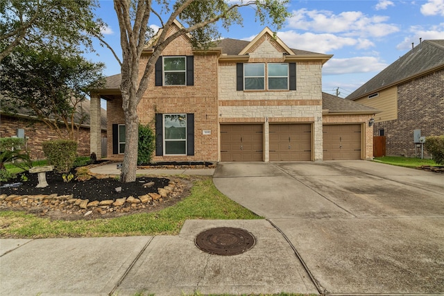 traditional home featuring a garage, brick siding, a shingled roof, driveway, and stone siding