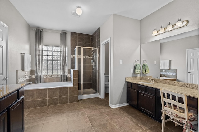 full bath with a stall shower, toilet, tile patterned floors, a garden tub, and vanity