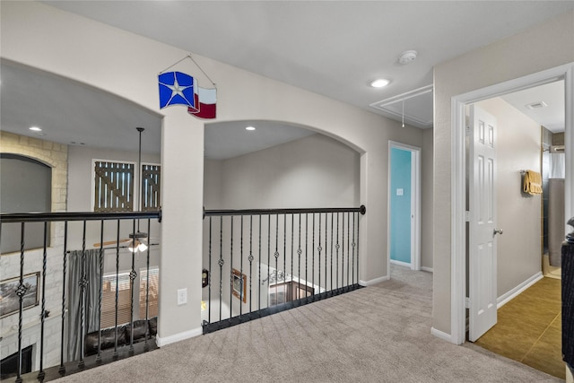 hallway featuring recessed lighting, carpet, attic access, and baseboards