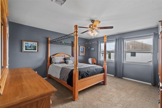 bedroom with carpet floors, visible vents, ceiling fan, and baseboards