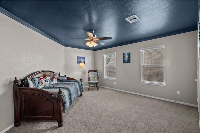 carpeted bedroom featuring baseboards, visible vents, and a textured ceiling