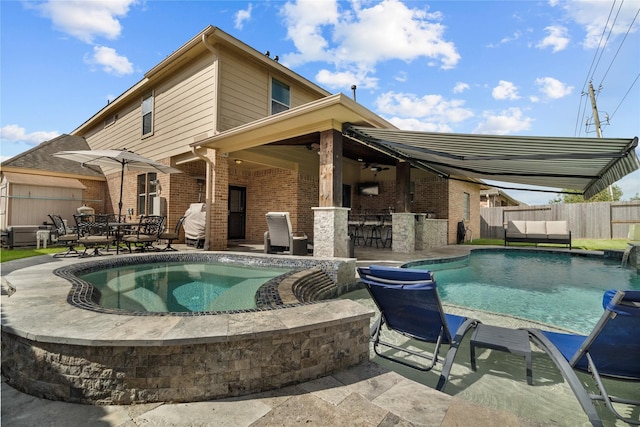 view of pool featuring a fenced in pool, a patio, outdoor dry bar, fence, and an in ground hot tub