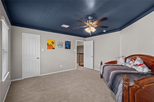 bedroom featuring baseboards, visible vents, ceiling fan, carpet, and crown molding