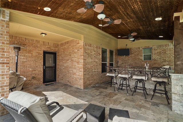 view of patio / terrace featuring outdoor dry bar and a ceiling fan