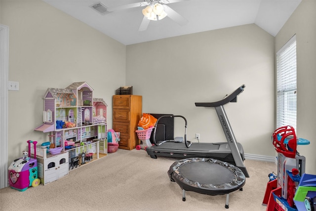 exercise room featuring lofted ceiling, a ceiling fan, visible vents, and carpet floors