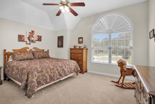 bedroom featuring light carpet, ceiling fan, baseboards, and vaulted ceiling