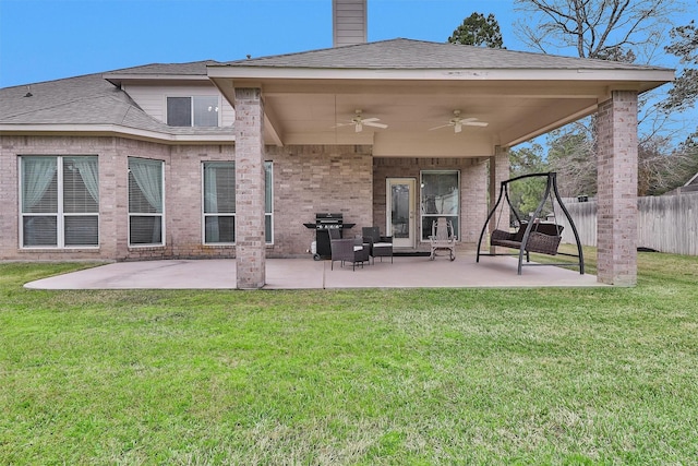 rear view of house featuring a lawn, ceiling fan, a patio, and fence