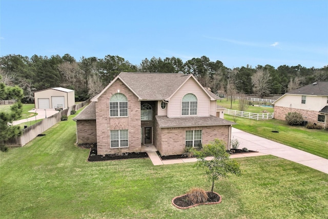 traditional home featuring roof with shingles, a front lawn, and fence