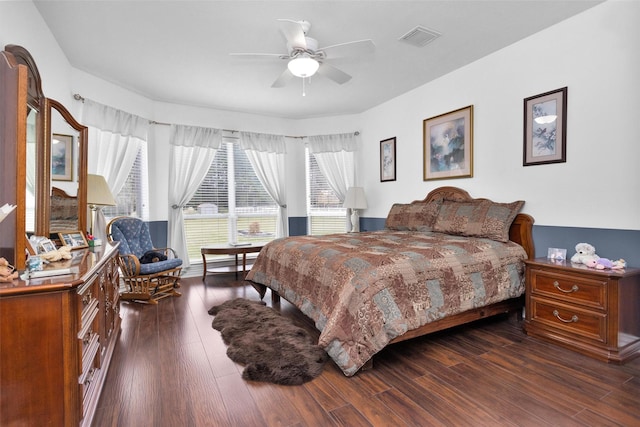 bedroom featuring visible vents, dark wood-type flooring, and a ceiling fan