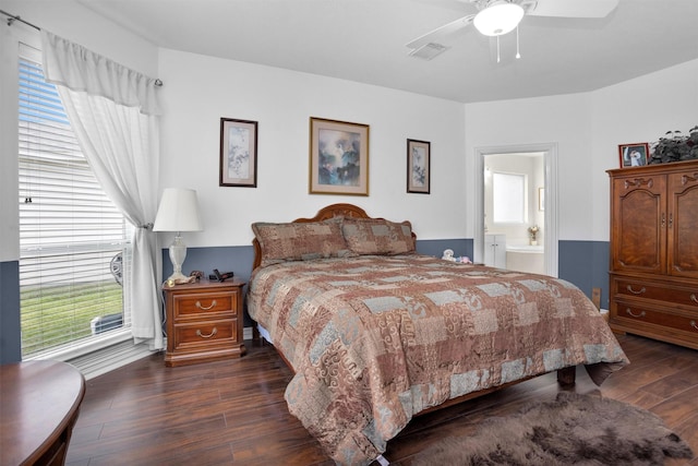 bedroom with dark wood-type flooring, visible vents, ensuite bathroom, and ceiling fan