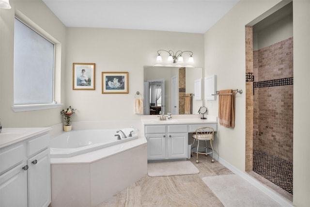 bathroom featuring a garden tub, vanity, and walk in shower