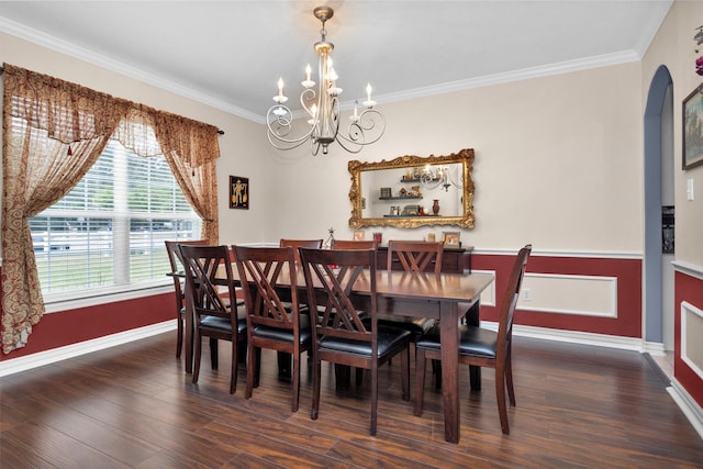 dining room featuring arched walkways, ornamental molding, and wood finished floors