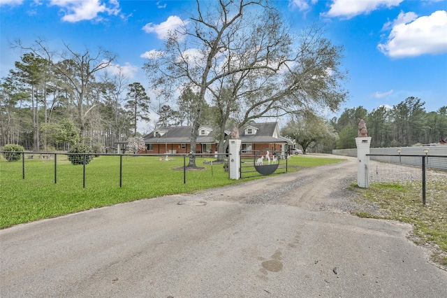 view of street with driveway and a gated entry