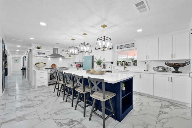 kitchen featuring open shelves, wall chimney range hood, gas range, marble finish floor, and a sink